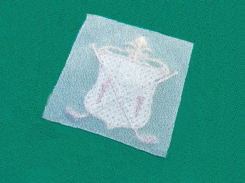 Fabric embroidery cover with adhesive