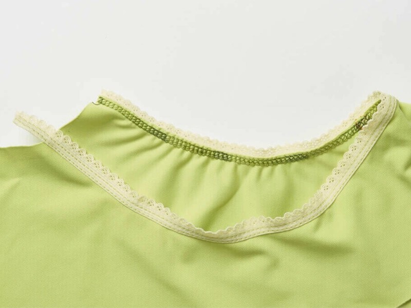 Foot for sewing lace to the edge of the material